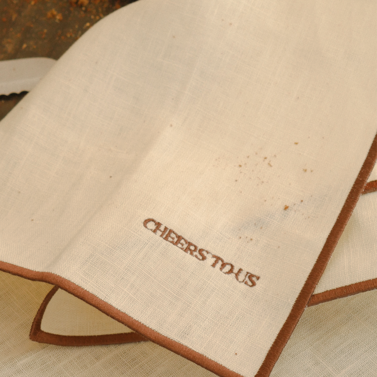 Napkins 'cheers to us' in beige 